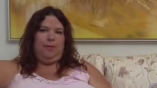 Obese lady plays with a pink dildo while moaning softly